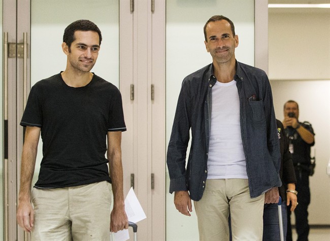John Greyson, right, and Tarek Loubani arrive at the Pearson International Airport in Toronto, Friday October 11, 2013.