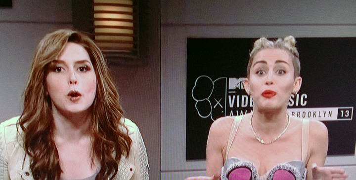 Vanessa Bayer and Miley Cyrus in the opening sketch on 'SNL.'.