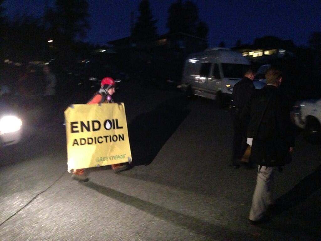 A protester is escorted into a waiting RCMP cruiser.