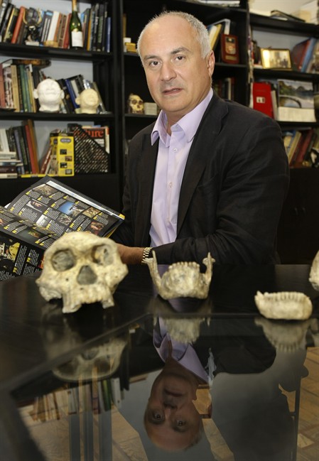 In this photo taken Oct. 2, 2013, David Lordkipanidze, director of the Georgia National Museum, displays the ancient skull and jaws of a pre-human ancestor at the National Museum in Tbilisi, Georgia, Wednesday, Oct. 2, 2013.
