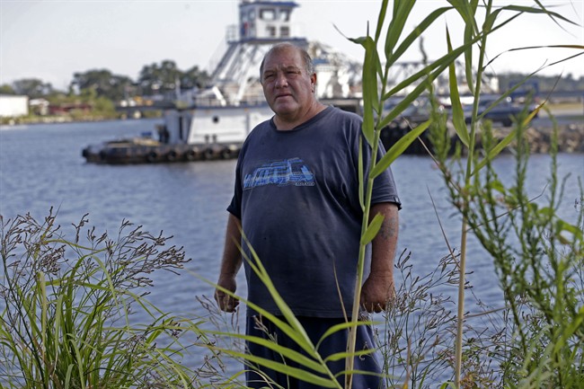 In this Wednesday, Oct. 9, 2013 photo, Calvin Parker, Jr., stands in the area where he and fellow Mississippian Charles Hickson were allegedly abducted by aliens on Oct. 11,1973, on the banks of the Pascagoula River in Pascagoula Miss.