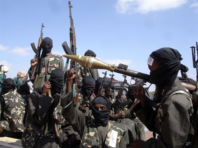 In this Dec. 8, 2008 file photo, armed al-Shabab fighters just outside Mogadishu prepare to travel into the city in pickup trucks after vowing there would be new waves of attacks against Ethiopian troops. 