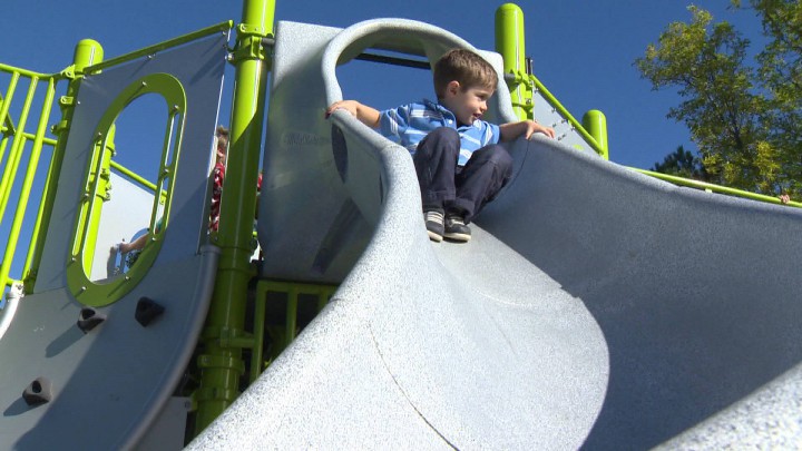 A young boy tests the new 'big' slide at the pirate-ship-shaped playground at Alderney Landing.