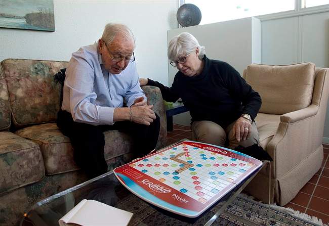 Sandra Atlin plays Scrabble with her husband Gordon, who has Alzheimer's disease, at their home in Toronto on Friday, Oct. 11, 2013. 