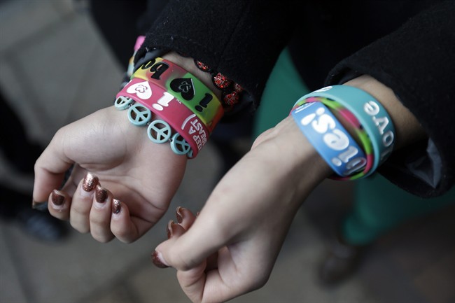 In this Feb. 20, 2013 file photo, Easton Area School District students Brianna Hawk, 15, left, and Kayla Martinez, 14, display their "I (heart) Boobies!" bracelets for photographers outside the U.S. Courthouse in Philadelphia. 