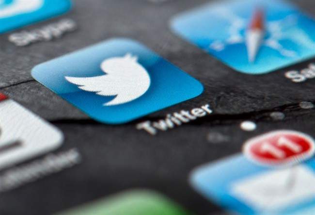 A smartphone display shows the Twitter logo in Berlin, Germany, Twitter unsealed the documents Thursday, Oct. 3, 2013, for its planned initial public offering of stock and says it hopes to raise up to $1 billion. (AP Photo/dpa, Soeren Stache, File).
