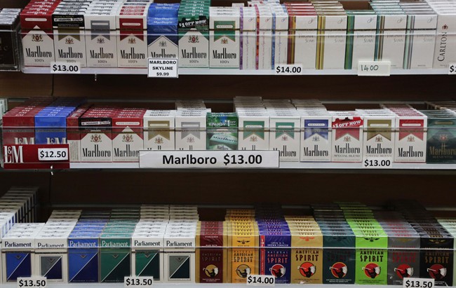 FILE- In this March 18, 2013 file photo, cigarette packs are displayed at a convenience store in New York. 