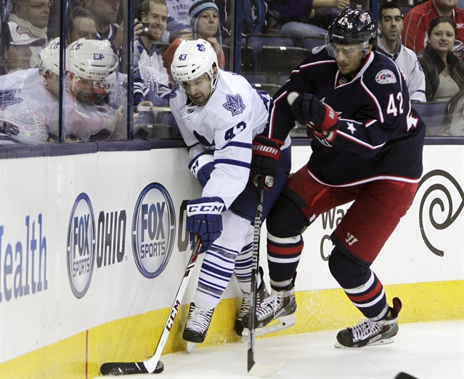 Toronto Maple Leafs' Nazem Kadri, left, and Columbus Blue Jackets' Artem Anisimov, of Russia, chase a loose puck during the first period of an NHL hockey game on Friday, Oct. 25, 2013, in Columbus, Ohio.