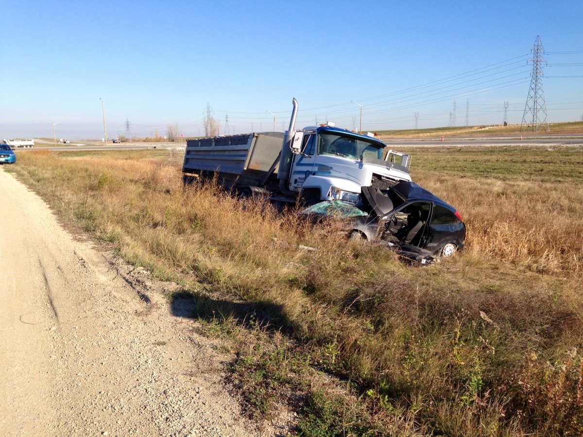 A gravel truck and a car crashed on the Perimeter Highway at Gunn Road in Winnipeg on Friday.