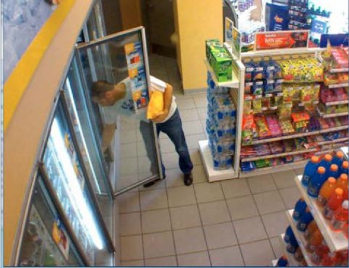 Police surveillance of Ford and Lisi with packages at a Scarlett Road gas station - image
