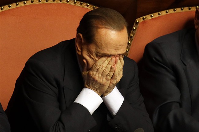 FILE - In this Wednesday, Oct. 2, 2013 file photo Silvio Berlusconi rubs his eyes after delivering his speech at the Senate, in Rome. 