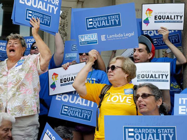 FILE- In this June 27, 2013 file photo, advocates for gay marriage in New Jersey gather outside the Statehouse in Trenton, N.J. 