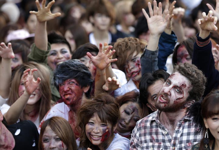 Participants in zombie costumes perform during a Halloween event at Tokyo Tower in Tokyo, Thursday, Oct. 31, 2013.