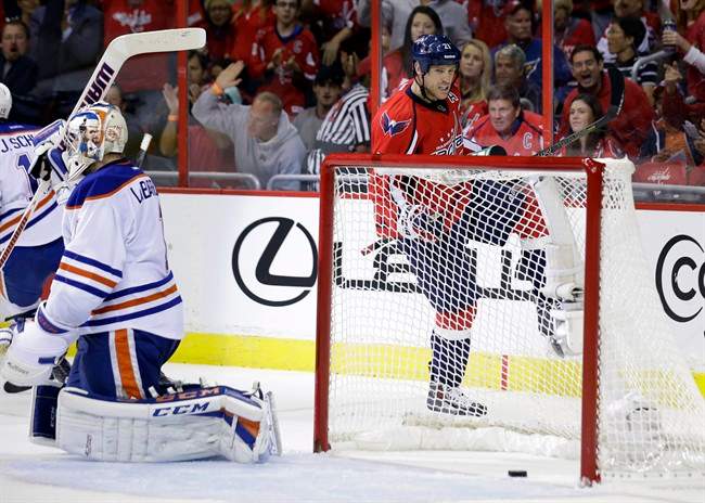 Washington Capitals center Brooks Laich (21) celebrates his goal pat Edmonton Oilers goalie Jason LaBarbera (1) in the first period of an NHL hockey game, Monday, Oct. 14, 2013, in Washington . 