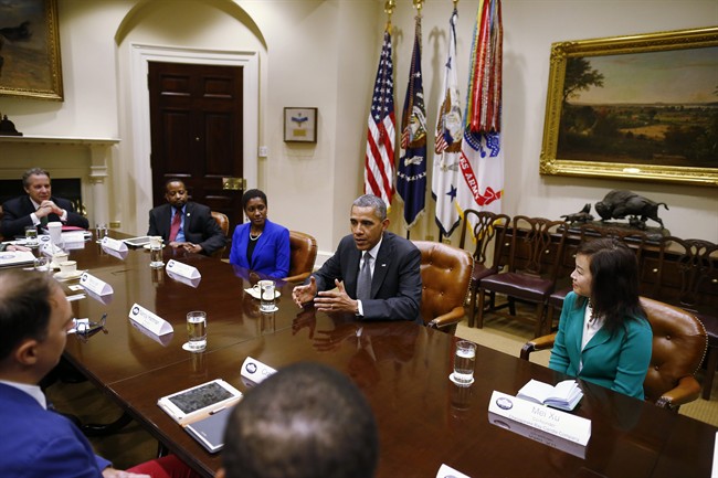President Barack Obama meets with small business owners to talk about the government shutdown and debt ceiling, Friday, Oct. 11, 2013, in the Roosevelt Room of the White House in Washington. 