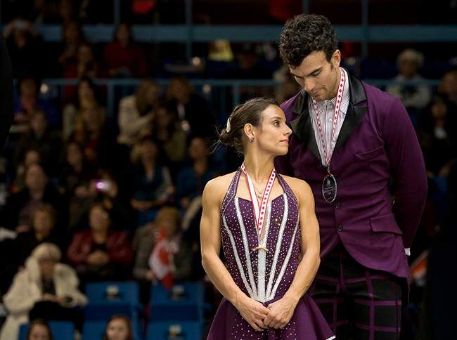 Meagan Duhamel and Eric Radford of Canada stand on the podium after placing third in the pairs event at Skate Canada International in Saint John, N.B. on Saturday, Oct.26, 2013. THE CANADIAN PRESS/Andrew Vaughan.