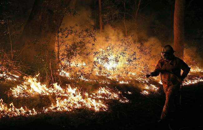 Firefighters control flames during hazard reduction in Bilpin 75 kilometers (46 miles) from Sydney in Australia, Wednesday, Oct. 23, 2013. Read the latest about the Australia wildfires here. (Photo credit: AP Photo).