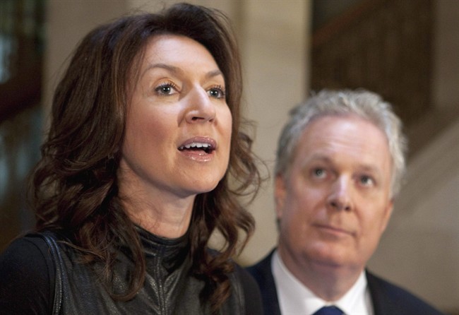 Quebec Deputy premier Nathalie Normandeau resigns as Quebec Premier Jean Charest looks on, on September 6, 2011 in Quebec City.