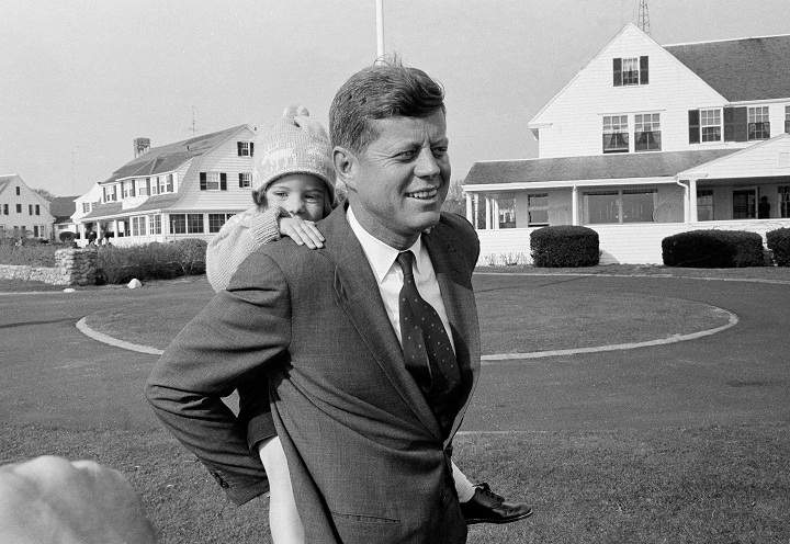 In this Nov. 9, 1960 file photo, Caroline Kennedy gets a piggy-back ride from her father, Sen. John F. Kennedy, in Hyannis Port, Mass. It was the first chance in weeks Kennedy has had to relax with his daughter during his presidential campaign. (AP Photo)