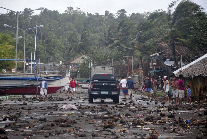Debris litter the road by the coastal village in Legazpi city following a storm surge brought about by powerful Typhoon Haiyan in Albay province. (AP Photo/Nelson Salting)