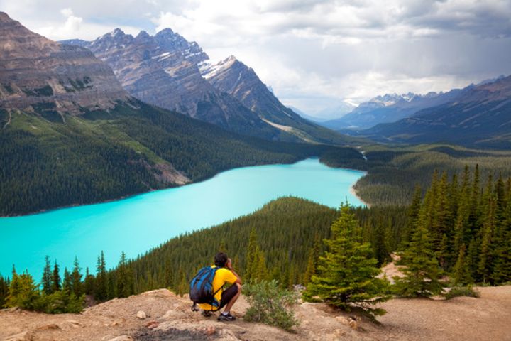 A tourist pauses for a photo of Peyton Lake in Banff National Park. 