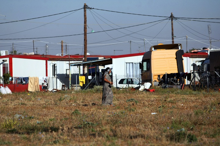 A Roma woman walks next to a Roma settlement in Farsala, central Greece, on October 21, 2013, where a four-year-old girl reportedly named Maria, was found living with a Roma couple who were arrested after DNA tests showed they were not related.