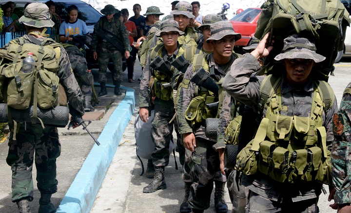 FILE- Philippine police commandos prepare to board a C-130 military plane in Manila on November 10, 2013.