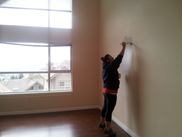 Lien Truong paints the wall of the Coquitlam townhouse she bought with fiancé Jesse Schmidt.