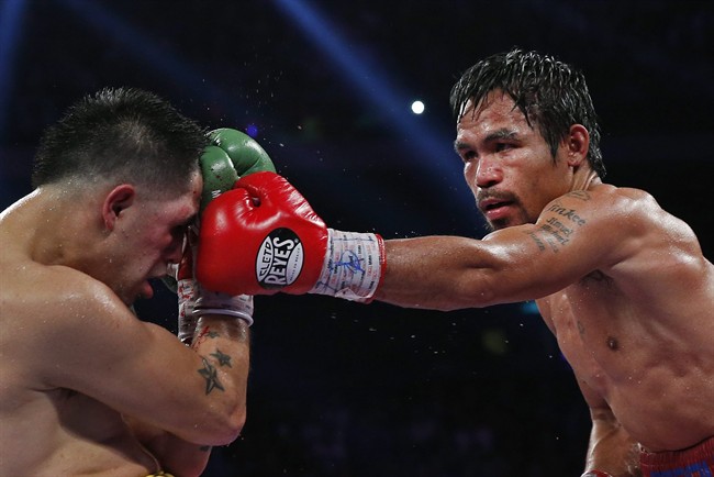 Manny Pacquiao, from the Philippines, right, lands a left to the head of Brandon Rios of the United States during their WBO international welterweight title fight Sunday, Nov. 24, 2013, in Macau.