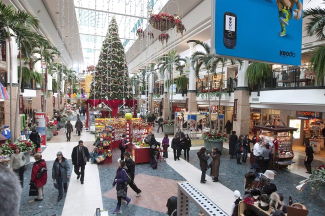 Christmas shoppers walk to stores at the Laurier shopping centre in Quebec City, Thursday, December 16, 2010.