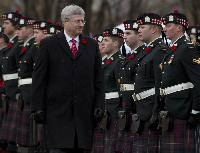 Canadian Prime Minister Stephen Harper inspects the honour guard as he participates in a ceremony at the cenotaph at Crysler's Farm, east of Morrisburg, Ont. Monday November 11, 2013. The battle of Crysler's Farm was fought on Nov.11, 1813. THE CANADIAN PRESS/Adrian Wyld.