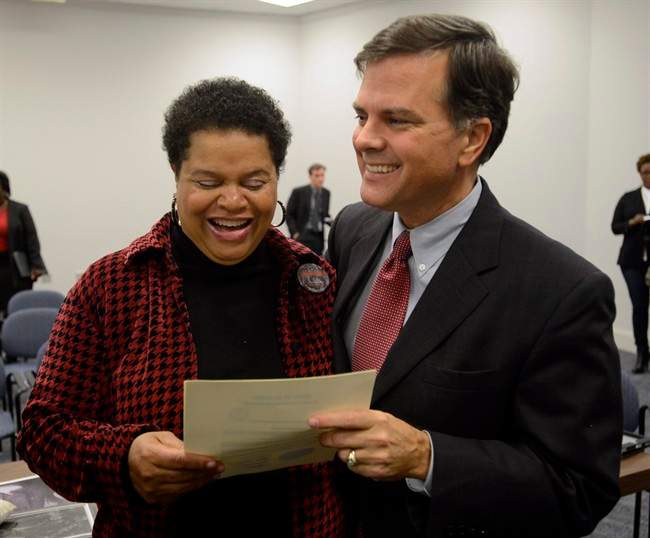 Sheila Washington, director of the Scottsboro Boys Museum and Cultural Center, and Sen. Arthur Orr, R-Decatur, celebrate as the Alabama Board of Pardons and Paroles pardons three of the Scottsboro Boys on Thursday, Nov. 21, 2013, in Montgomery, Ala.