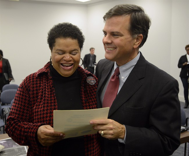 Sheila Washington, director of the Scottsboro Boys Museum and Cultural Center, and Sen. Arthur Orr, R-Decatur, celebrate as the Alabama Board of Pardons and Paroles pardons three of the Scottsboro Boys on Thursday, Nov. 21, 2013, in Montgomery, Ala.