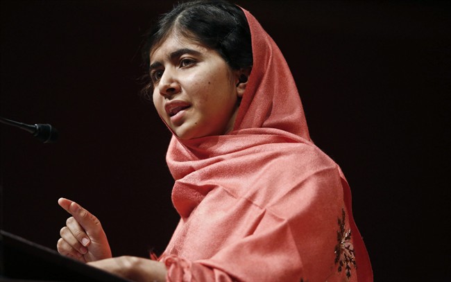 In this Friday, Sept. 27, 2013 file photo, Malala Yousafzai addresses students and faculty after receiving the 2013 Peter J. Gomes Humanitarian Award at Harvard University in Cambridge, Mass. 