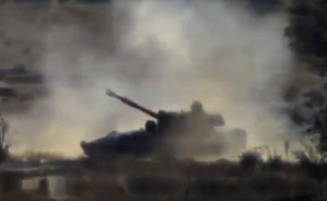 In this image taken from video obtained from the Shaam News Network, which has been authenticated based on its contents and other AP reporting, a government soldier bombs neighborhoods near the al-Maza airport, in Damascus countryside, Syria, on Monday, Nov. 4, 2013.