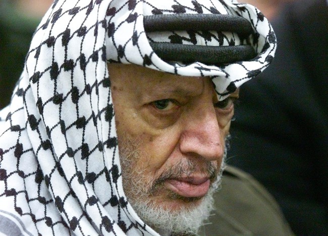  In this May 31, 2002 file photo, Palestinian leader Yasser Arafat pauses during the weekly Muslim Friday prayers in his headquarters in the West Bank city of Ramallah. Extensive reports by French scientists into Palestinian leader Yasser Arafat's death have ruled out poisoning by radioactive polonium, his widow said Tuesday. 