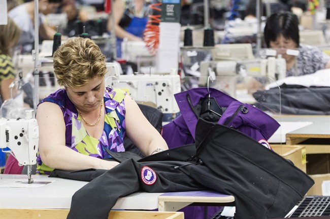A Canada Goose employee sews a jacket at the company's factory in Toronto on Friday November 8, 2013.THE CANADIAN PRESS/Chris Young.