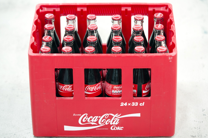 Coca-Cola soft drink bottles on an assembly line at a Coca Cola bottling plant.