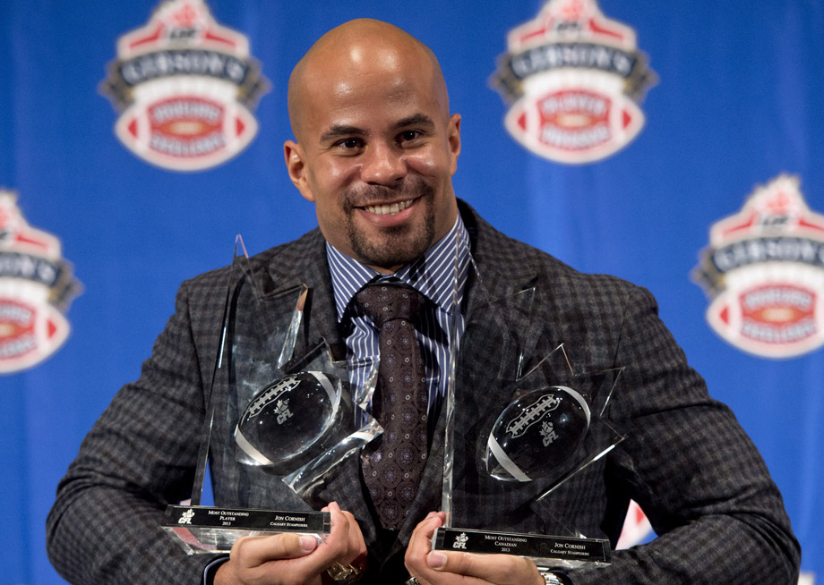 Jon Cornish of the Calgary Stampeders holds his trophies for the most outstanding player and the most outstanding Canadian at the CFL Players Awards Thursday November 21, 2013 in Regina.