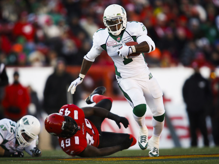 Saskatchewan Roughriders' Kory Sheets, right, gets away from Calgary Stampeders' Cordarro Law during first half CFL West Final football action in Calgary, Alta., Sunday, Nov. 17, 2013. The Riders advanced to the 101st Grey Cup in Regina with a 35-13 victory over the Stampeders.