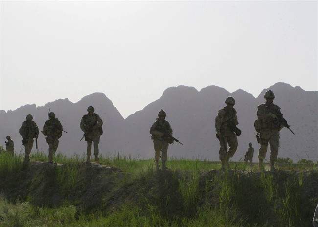 Canadian soldiers patrol an area in the Dand district of southern Afghanistan on Sunday, June 7, 2009. 