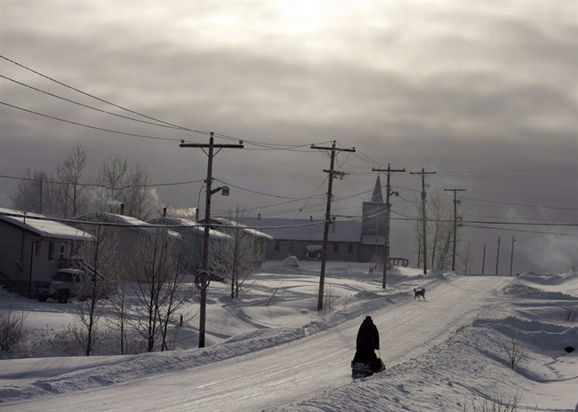 A snowmobile rides down the main street December 18, 2012, on the Fort Hope First Nation, Ont. A major U.S. player in northern Ontario's Ring of Fire says it's indefinitely suspending its chromite project in the mineral-rich area.