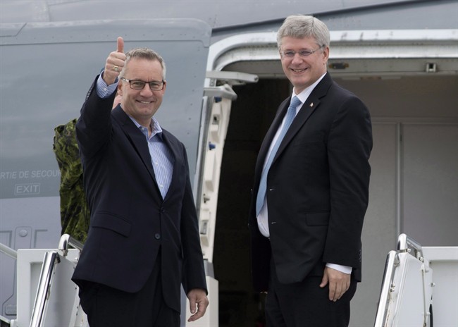 Canadian Prime Minister Stephen Harper, right, and International Trade Minister Ed Fast, leave Ottawa for Europe on October 17, 2013. THE CANADIAN PRESS/Adrian Wyld.