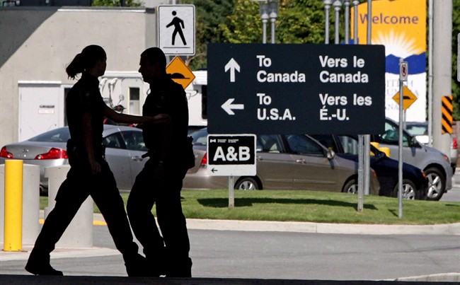 Canadian border guards silhouetted at the Douglas border crossing on the Canada-USA border. 