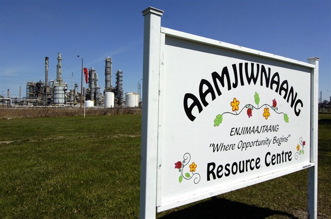 A sign for the Aamjiwnaang First Nation Resource Centre is located across the road from NOVA Chemicals in Sarnia, Ont., on April 21, 2007.