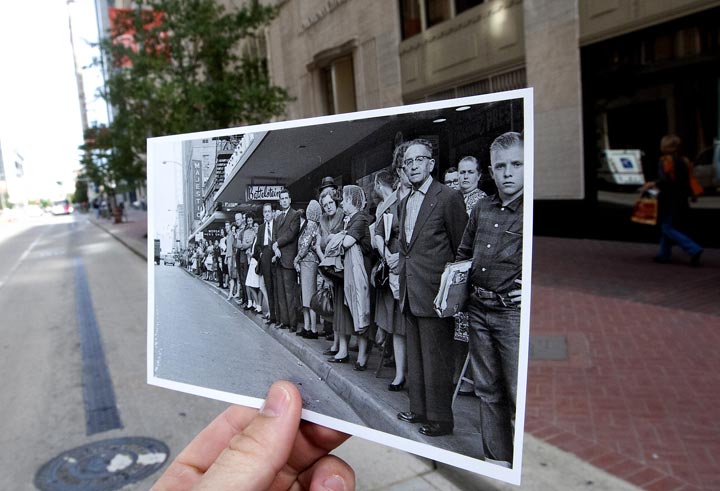 This Nov. 7, 2013 photo shows an image taken Nov. 21, 1963, of people lining Travis Street near Rusk Street to see U.S. President John F. Kennedy's motorcade during a visit to Houston, juxtaposed against the current scene in Houston. Kennedy was assassinated the following day. (AP Photo/Houston Chronicle, Cody Duty) 
.