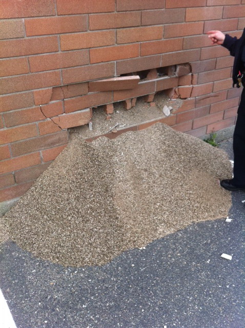 Damage to the exterior wall of the community policing office.