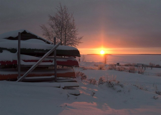 Canoes are stacked for the winter as the sun rises Tuesday, December 18, 2012, on the Fort Hope First Nation, Ont.