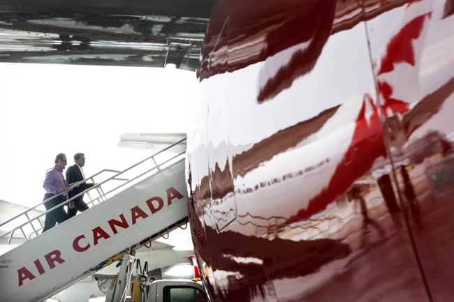 Guests climb aboard a plane in an Air Canada in Toronto on June 25, 2013.