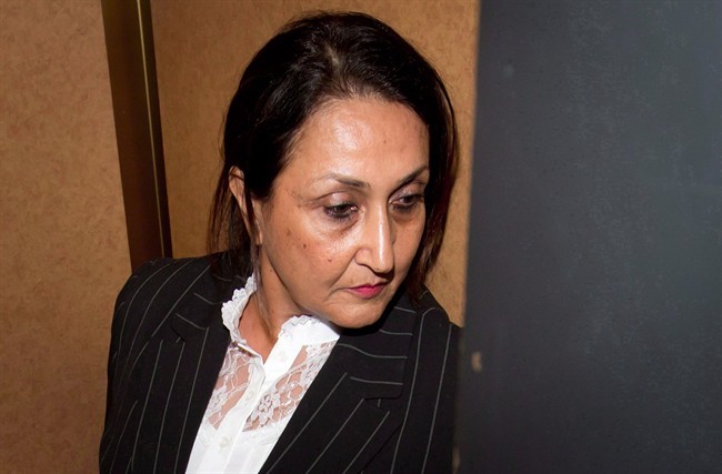 Mumtaz Ladha gets into an elevator to go back into court from an underground parkade while trying to avoid having her photograph taken at the end of the first day of a human trafficking trial at B.C. Supreme Court in Vancouver, B.C., on Wednesday September 4, 2013.